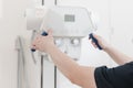 X-ray department in modern hospital. Radiology room with scan machine with empty bed. Technician adjusting an x-ray Royalty Free Stock Photo