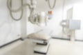 X-ray room blur background of empty radiological imaging scan equipment laboratory in blurry medical clinic or general hospital