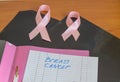 X-rays, two pink ribbons and a pink file folder lie on the table as a symbol of breast cancer awareness and prevention Royalty Free Stock Photo