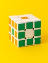 3x3 Rubik's cube isolated on yellow background. 3 by 3 Logic puzzle.