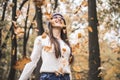 It& x27;s so fun!Young girl throwing leaves in the autumnal park Royalty Free Stock Photo