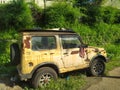 90& x27;s jeep parked on the side of a residential road that looks neglected