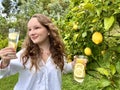 it's just a lemon paradise, a teenage girl stands against the backdrop of a lemon tree with lemons and drinks Royalty Free Stock Photo