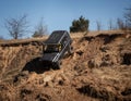 4x4 suv truck driving downhill on edge of hill Royalty Free Stock Photo