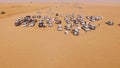 4x4 SUVs cars driving through the sand dunes in the desert of Abu Dhabi. Stock. Top view on SUVs in the desert