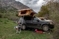 4x4 SUVs with rooftop tents standing on camping in the mountains