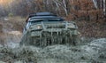 4x4 travel trekking. Track on mud. Off-road vehicle goes on the mountain. Mud and water splash in off road racing Royalty Free Stock Photo