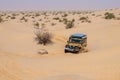4X4 vehicle drives around the sand dunes of the Sahara Desert.