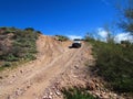 4x4 Vehicle Driving on Steep Dirt Road in Arizona Royalty Free Stock Photo