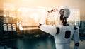 XAI Humanoid AI robot looking at hologram screen showing concept of big data Royalty Free Stock Photo