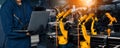 XAI Engineer use advanced robotic software to control industry robot arm in factory Royalty Free Stock Photo