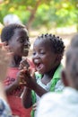 Close up of unidentified African girl playing clapping game unaware of the camera.