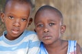 Close up front view of two unidentified African boys intrigued with the camera