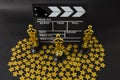 Plastic Oscar awards, a clapboard and golden stars confetti