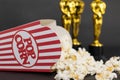 Classic popcorn box and three Oscar figurines blurred