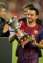 Xavi Hernandez of FC Barcelona holds up trophy