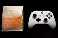 Xbox One games controller sat next to a bag of ground coffee against a dark black background Royalty Free Stock Photo