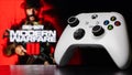 Xbox Series S Robot White Controller with Call of Duty Modern Warfare III game blurred in the background Royalty Free Stock Photo