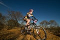 XCO Lady racing at the top of a climb