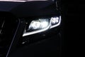 Macro view of modern black car xenon lamp headlight 12