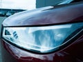 xenon led laser light of a red luxury car in large car parking Royalty Free Stock Photo