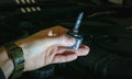 A xenon light bulb in the man's hand. A professional worker changes the new xenon lamps of the car