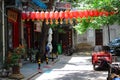 A narrow street decorated with traditional Chinese red lanterns in the downtown area. Old town Royalty Free Stock Photo
