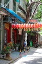 A street decorated with traditional Chinese red lanterns under the shade of trees in the downtown area. Royalty Free Stock Photo