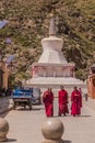 XIAHE, CHINA - AUGUST 24, 2018: Stupa and Buddhist monks of Labrang Monastery in Xiahe town, Gansu province, Chi