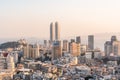 Xiamen city skyline with modern buildings, twin towers, old town and sea at dusk