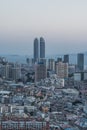 Xiamen city skyline with modern buildings, twin towers, old town and sea at dusk