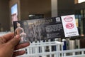 Xian, China - December 29, 2019: Asian hand holding entrance ticket in front of the entrance terracotta warriors at the museum
