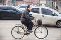 Chinese man riding his bicycle on a busy street of Xian, China