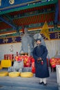 XIAN, CHINA - SEP 06, 2013: Middle-aged Taoist priest wears a silken, black Manchurian hat and a traditional deep-blue