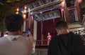 Tourists watching Chinese Opera singer onstage