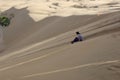 Girl sliding sand on the great sand dunes of xiangsha sand bay, adobe rgb
