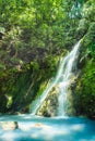 Xiao Yintang Waterfall of Yangmingshan National Park with milky cold spring and sunlight on sunny day, shot in Taipei, Taiwan. Royalty Free Stock Photo