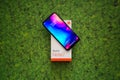 Xiaomi Redmi Note 7 smartphone on green leaves background