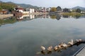 Xidi Ancient Town in Anhui Province, China. Ducks on Ming Jing Lake with the old town behind
