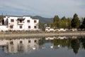 Xidi Ancient Town in Anhui Province, China. A house in the old town seen across Ming Jing Lake with ducks