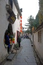 Xidi Ancient Town in Anhui Province, China. A storekeeper waits as tourists explore the historic town