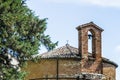 XIII century baptistery church with brick wall and small bell