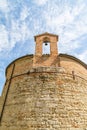 XIII century baptistery church with brick wall and small bell