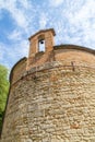 XIII century baptistery church with brick wall and small bell