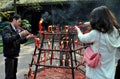 Xindu, China: People Lighting Incense Sticks