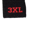 3XL size clothing label tag, black fabric, red XXXL embroidery text, isolated vertical, large detailed macro closeup Royalty Free Stock Photo