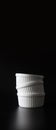 XL Size White ramekins stacked on black background with copy space Royalty Free Stock Photo