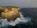 Xlendi Tower and rocky coastline with waves after storm aerial Gozo Malta Royalty Free Stock Photo