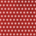 White snowflakes on red wooden background