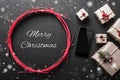 Xmas background with gifts and mobile phone space with christmas snowing message Royalty Free Stock Photo